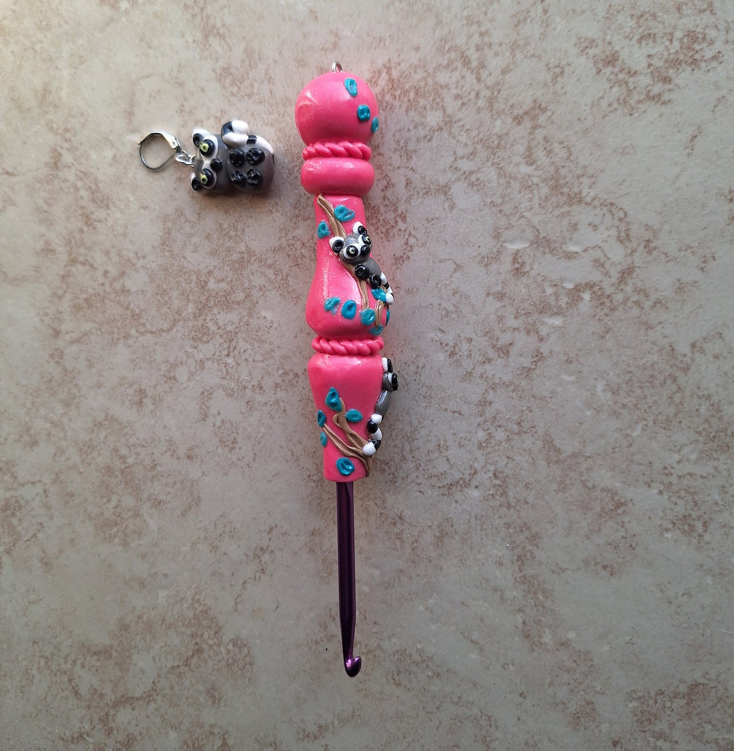Polymer clay pink glitter lemur on branch crochet hook