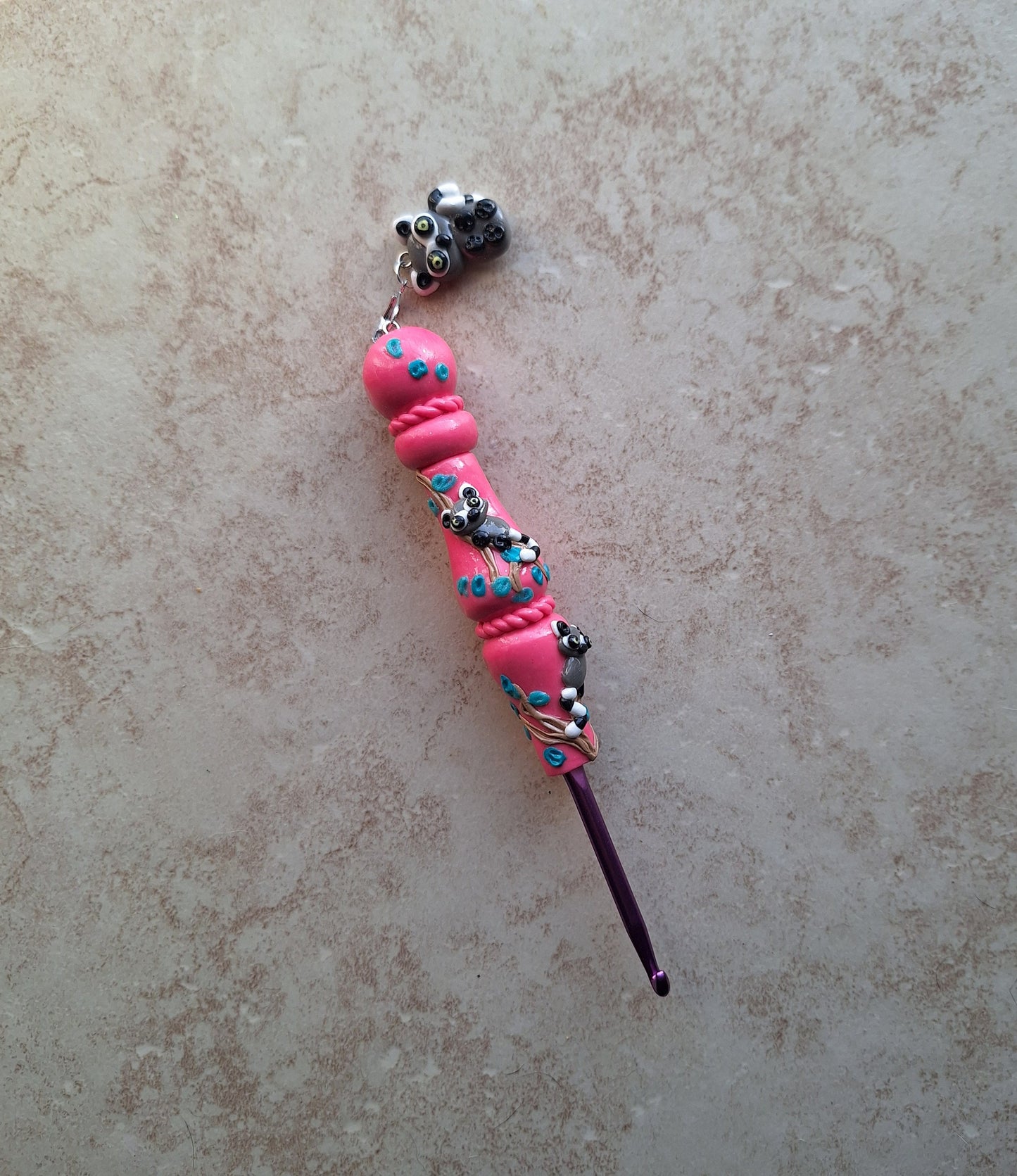 Polymer clay pink glitter lemur on branch crochet hook