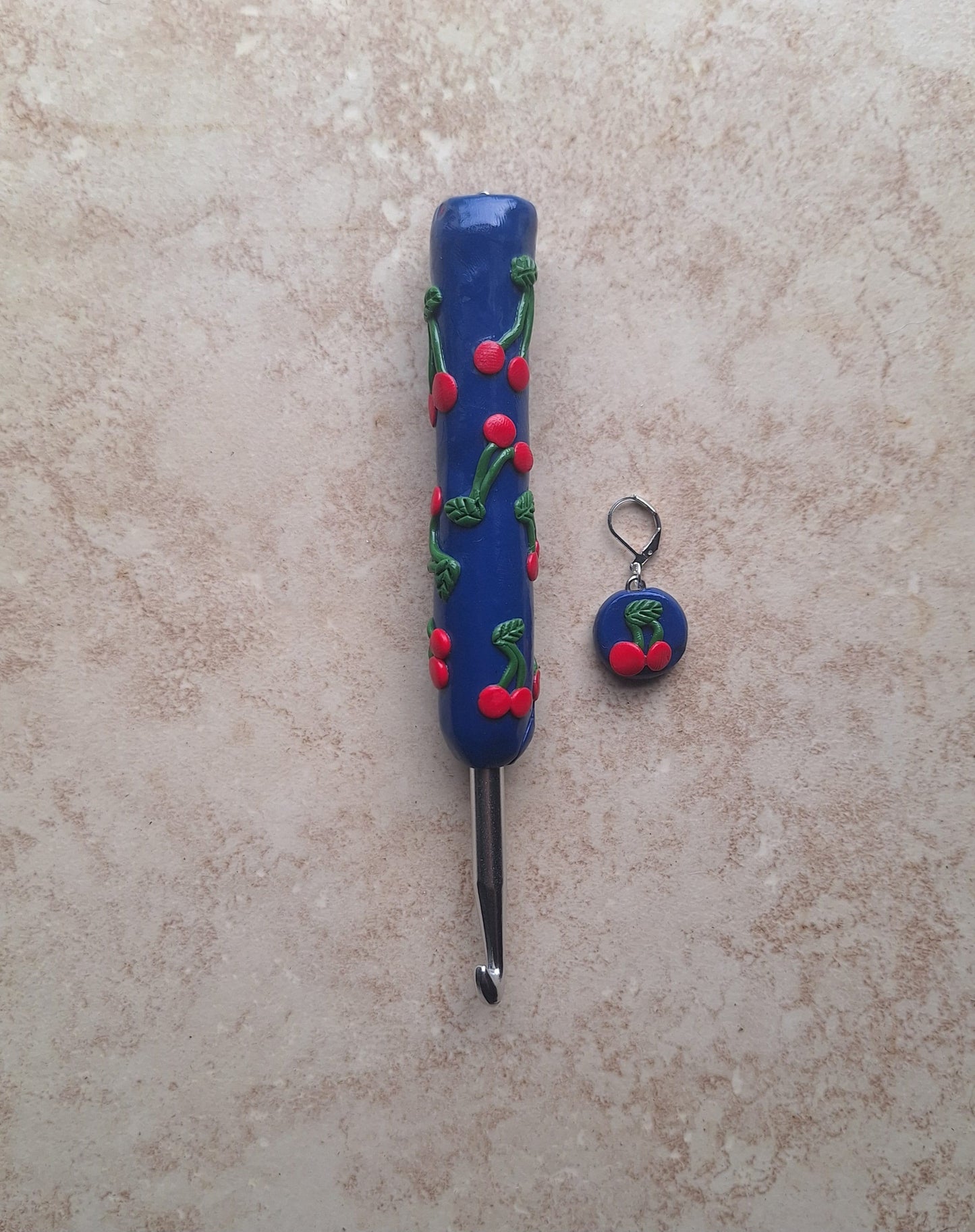Polymer clay fruit cherries on navy crochet hook with stitch marker