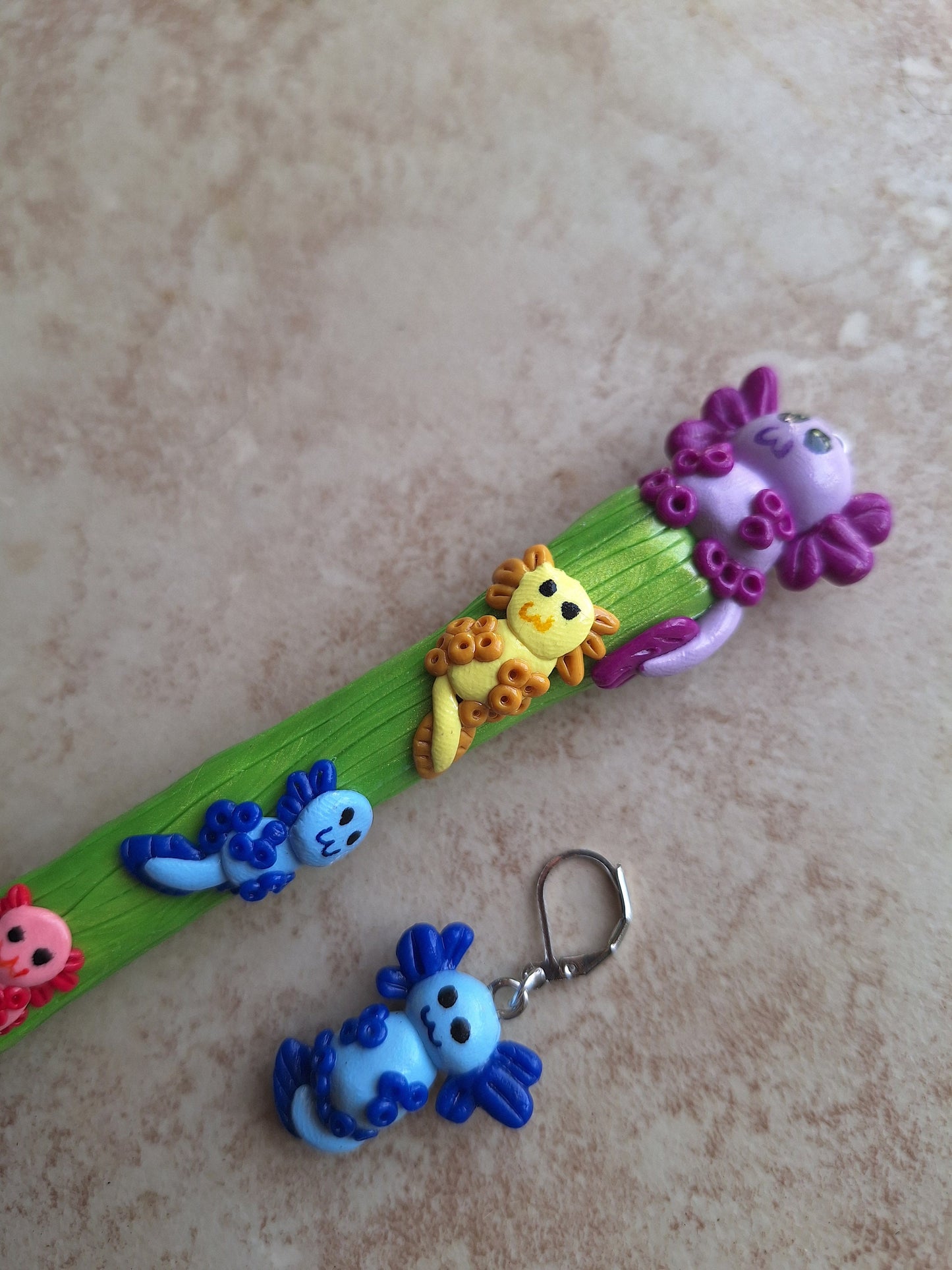 Polymer clay colorful axolotl crochet hook with stitch marker