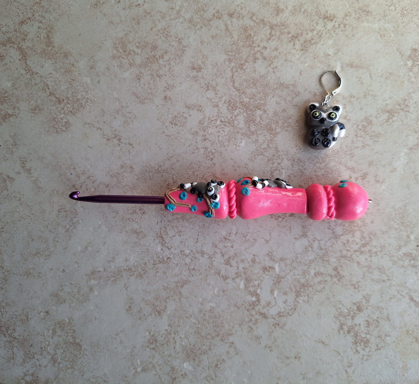 Polymer clay pink glitter lemur on branch crochet hook