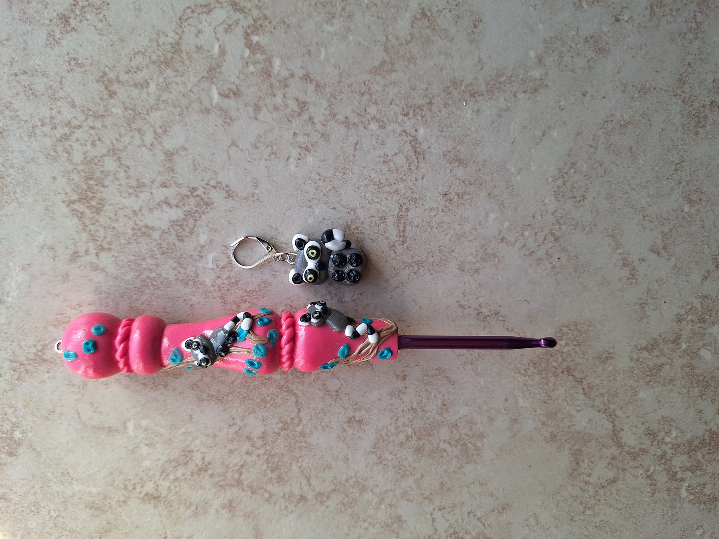 Polymer clay pink glitter lemur on branch crochet hook