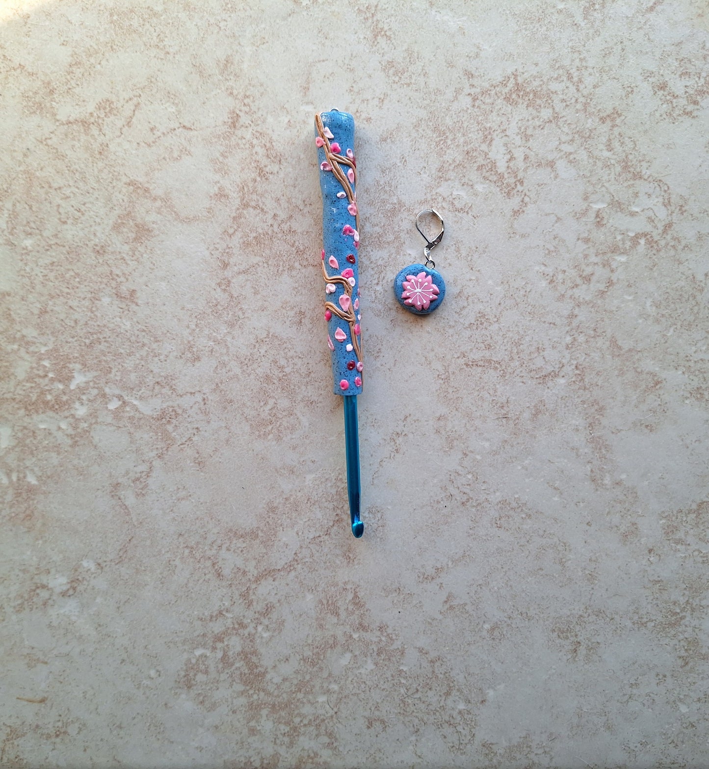 Polymer clay spring floral Sakura on blue crochet hook