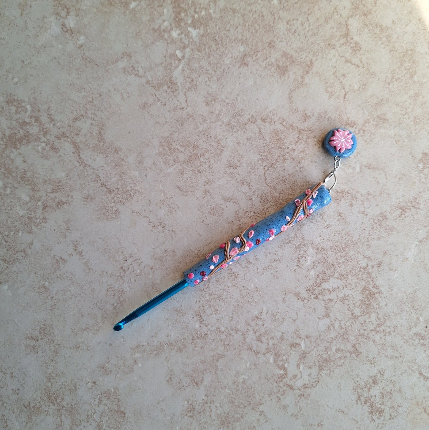 Polymer clay spring floral Sakura on blue crochet hook