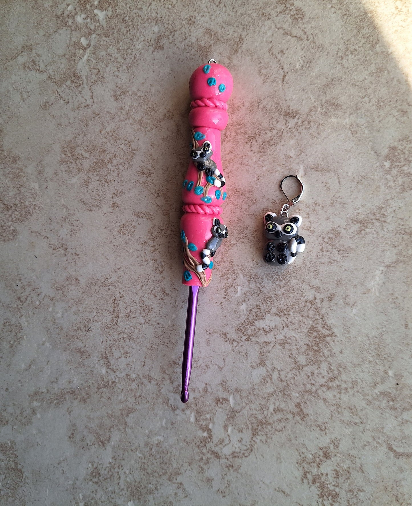 Polymer clay pink glitter lemur on branch crochet hook