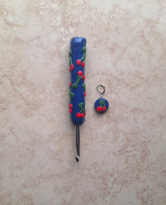Polymer clay fruit cherries on navy crochet hook with stitch marker
